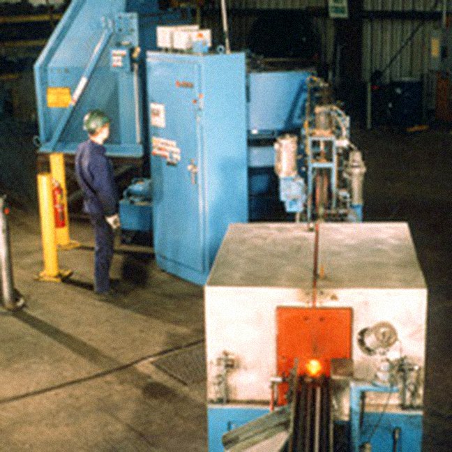 Induction heating cell with a glowing hot billet at Lincoln Forge